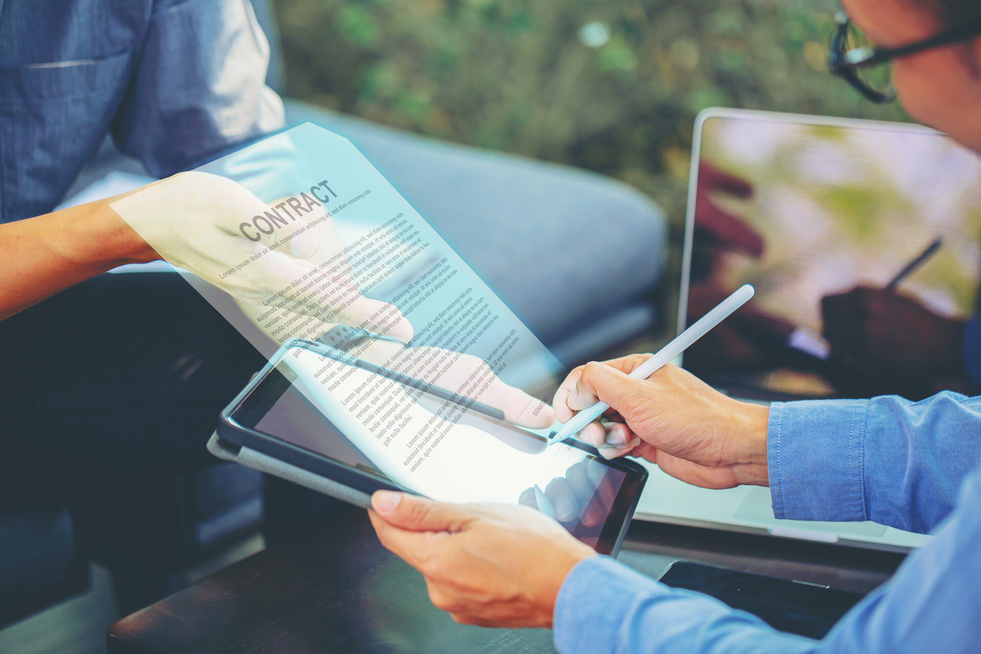 Init.Sign electronic signature — person signing a contract digitally on tablet integrated with Salesforce