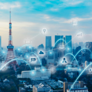 Smart city skyline with IoT, network and data connectivity icons overlay representing Industry 4.0 manufacturing operations