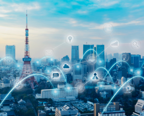 Smart city skyline with IoT, network and data connectivity icons overlay representing Industry 4.0 manufacturing operations